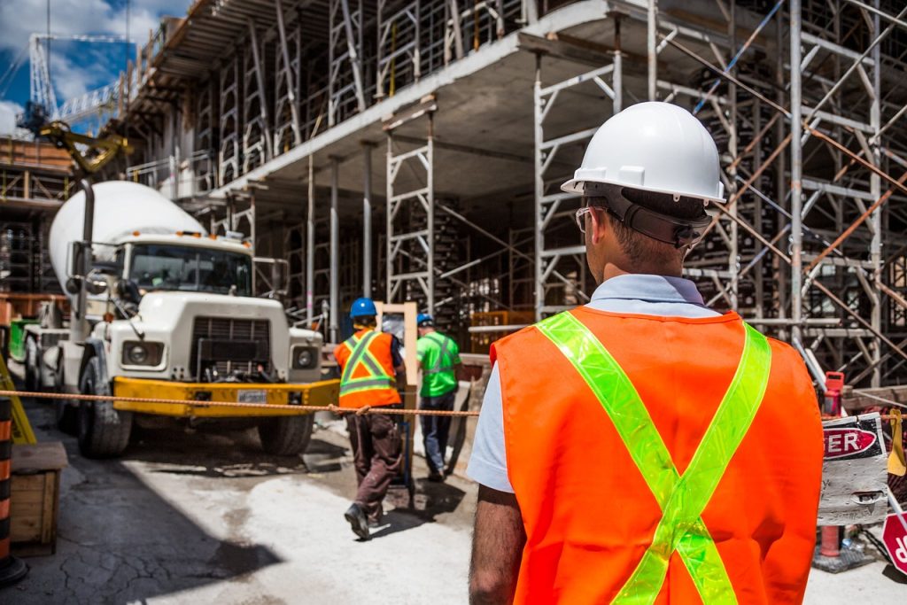 Photograph of Construction worker on work site wearing orange safety vest